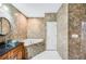 Beautiful bathroom featuring a vessel sink, tub, and elegant stone-look tile at 1553 Wright Dr, Lakeland, FL 33805