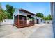 Inviting outdoor lounge area featuring wood deck, with a TV and comfortable seating, perfect for relaxation and entertainment at 1553 Wright Dr, Lakeland, FL 33805