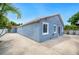Beautiful single-story home showcasing a concrete driveway, complimented by lush, tropical landscaping, and vibrant blue siding at 1553 Wright Dr, Lakeland, FL 33805