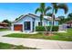 Charming single-story home with lush lawn and two palm trees enhancing curb appeal at 1553 Wright Dr, Lakeland, FL 33805