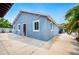 Charming single-story home featuring a concrete driveway, complemented by lush, tropical landscaping and vibrant blue exterior at 1553 Wright Dr, Lakeland, FL 33805