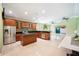 Open-concept kitchen with stainless steel appliances, dark granite countertops, and tile floors at 1553 Wright Dr, Lakeland, FL 33805