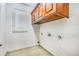 Utility room with window, upper cabinets, and tile floor at 1553 Wright Dr, Lakeland, FL 33805