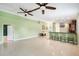 Spacious living area with tile flooring, ceiling fans, and bar seating, perfect for entertaining guests at 1553 Wright Dr, Lakeland, FL 33805