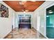 Living room with wood ceiling, built in cabinets, tile flooring, and natural light at 1553 Wright Dr, Lakeland, FL 33805
