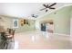 Bright living room featuring tile floors, ceiling fans, and sliding glass doors to outdoor spaces at 1553 Wright Dr, Lakeland, FL 33805