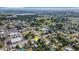 Aerial shot shows the home's location within a quiet neighborhood, near local amenities and a picturesque lake at 165 E Pierce St, Lake Alfred, FL 33850
