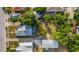 Overhead view displays the property's lot and roof, set among lush trees and neighboring houses at 165 E Pierce St, Lake Alfred, FL 33850