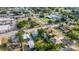 An aerial view of the property and its neighborhood features mature trees and nearby roads at 165 E Pierce St, Lake Alfred, FL 33850