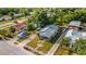 An aerial view shows the property nestled among trees, showcasing the neighborhood at 165 E Pierce St, Lake Alfred, FL 33850
