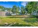Spacious backyard view featuring green grass and trees in a residential area at 165 E Pierce St, Lake Alfred, FL 33850