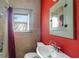 Cozy bathroom with a window, colorful wall, and a vanity sink with a mirror at 165 E Pierce St, Lake Alfred, FL 33850
