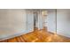 Spacious bedroom featuring hardwood floors, and doorway to closet space and a bathroom at 165 E Pierce St, Lake Alfred, FL 33850