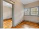 Bedroom featuring wood floors, windows, and doorway to another bedroom at 165 E Pierce St, Lake Alfred, FL 33850