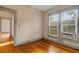 Bedroom featuring hardwood floors, natural light from the windows, and air conditioning unit at 165 E Pierce St, Lake Alfred, FL 33850