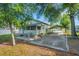 Charming home exterior with a screened porch and convenient carport at 165 E Pierce St, Lake Alfred, FL 33850