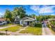 This charming home features a cozy front porch and driveway with a convenient carport at 165 E Pierce St, Lake Alfred, FL 33850