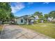 Single-story home featuring a convenient carport and inviting front porch, ideal for relaxed outdoor living at 165 E Pierce St, Lake Alfred, FL 33850