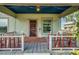 Welcoming front porch features a cozy seating area and classic details for relaxing outdoors at 165 E Pierce St, Lake Alfred, FL 33850