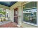 Charming front porch with rustic wood flooring and trim, complemented by decorative touches and a welcoming ambiance at 165 E Pierce St, Lake Alfred, FL 33850