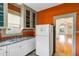 Bright eat-in kitchen featuring ample counter space, classic cabinets, and hardwood floors at 165 E Pierce St, Lake Alfred, FL 33850
