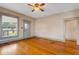 Bright living room featuring a large window, hardwood floors, and neutral paint at 165 E Pierce St, Lake Alfred, FL 33850
