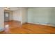 Open floor plan living room with hardwood floors, neutral walls, and entry door at 165 E Pierce St, Lake Alfred, FL 33850