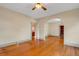 Spacious living room with arched doorway, ceiling fan, and beautiful hardwood floors at 165 E Pierce St, Lake Alfred, FL 33850
