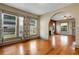 Living room with ample windows, hardwood flooring, and archway leading to another room at 165 E Pierce St, Lake Alfred, FL 33850