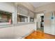 Sunroom area with windows, wooden floors and doorway to other rooms at 165 E Pierce St, Lake Alfred, FL 33850