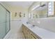Bright bathroom with shower and vanity with modern fixtures at 1929 4Th Ne St, Winter Haven, FL 33881