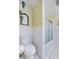 Well-lit bathroom with toilet and shower/tub combo and tile flooring at 1929 4Th Ne St, Winter Haven, FL 33881