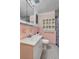 Pink tiled bathroom featuring a white vanity and ample storage at 1929 4Th Ne St, Winter Haven, FL 33881