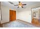 Bedroom with neutral walls, ceiling fan, and closet for ample storage at 1929 4Th Ne St, Winter Haven, FL 33881