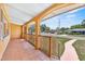 Charming covered porch with tiled flooring, offering a cozy outdoor space with views of the neighborhood at 1929 4Th Ne St, Winter Haven, FL 33881