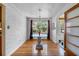 Bright dining area with hardwood floors, chandelier, and view of the front yard at 1929 4Th Ne St, Winter Haven, FL 33881