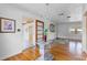 Charming dining room features a glass-top table, hardwood floors, and vintage chandelier at 1929 4Th Ne St, Winter Haven, FL 33881