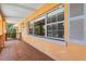 Inviting front porch with tile flooring and large windows, perfect for relaxing outdoors at 1929 4Th Ne St, Winter Haven, FL 33881
