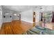 Open-concept living area boasts gleaming hardwood floors and seamless flow to the kitchen at 1929 4Th Ne St, Winter Haven, FL 33881