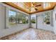 Enclosed sunroom with tiled floor, natural light, and windows at 1929 4Th Ne St, Winter Haven, FL 33881
