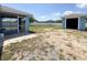 A back yard provides an exterior storage building and screened porch surrounded by a privacy fence at 2018 Misty Morning Dr, Winter Haven, FL 33880