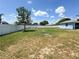 Fenced backyard with large tree offers ample space and privacy on a sunny day at 2018 Misty Morning Dr, Winter Haven, FL 33880