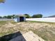 Large backyard with shed, grass, and a white privacy fence at 2018 Misty Morning Dr, Winter Haven, FL 33880