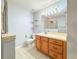Bathroom with a single sink vanity, mirror with lighting, and a tile floor at 2018 Misty Morning Dr, Winter Haven, FL 33880
