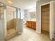 Bright bathroom features tiled shower, vanity with sink, and closet at 2018 Misty Morning Dr, Winter Haven, FL 33880