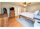 Comfortable bedroom featuring wood dresser, ceiling fan and wood frame bed at 2018 Misty Morning Dr, Winter Haven, FL 33880