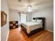 Bedroom with hardwood floors, a dresser, and a window providing natural light at 2018 Misty Morning Dr, Winter Haven, FL 33880