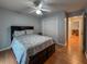 Bedroom with hardwood floors and a large bed, featuring a ceiling fan and closet at 2018 Misty Morning Dr, Winter Haven, FL 33880
