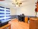 Well-lit bedroom featuring wood flooring, a ceiling fan, and blue accents at 2018 Misty Morning Dr, Winter Haven, FL 33880
