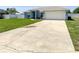 Well-kept home featuring a lush lawn, driveway, and tidy landscaping enhancing its curb appeal and welcome feel at 2018 Misty Morning Dr, Winter Haven, FL 33880
